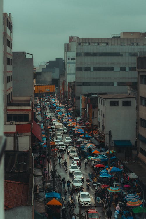 A view of a busy street with cars and umbrellas