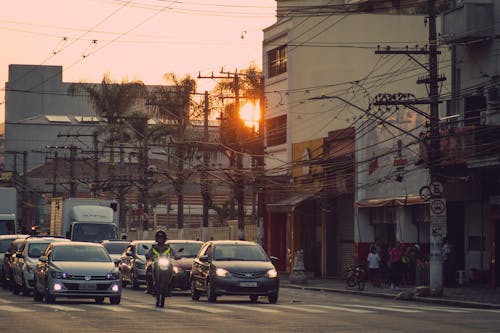 View of Vehicles on a Street in City at Sunset