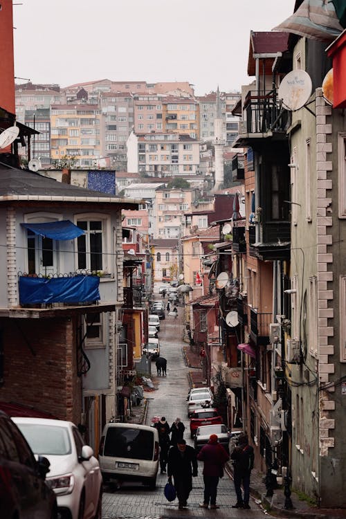 View of Pedestrians Walking in a Narrow Alley between Houses in Istanbul