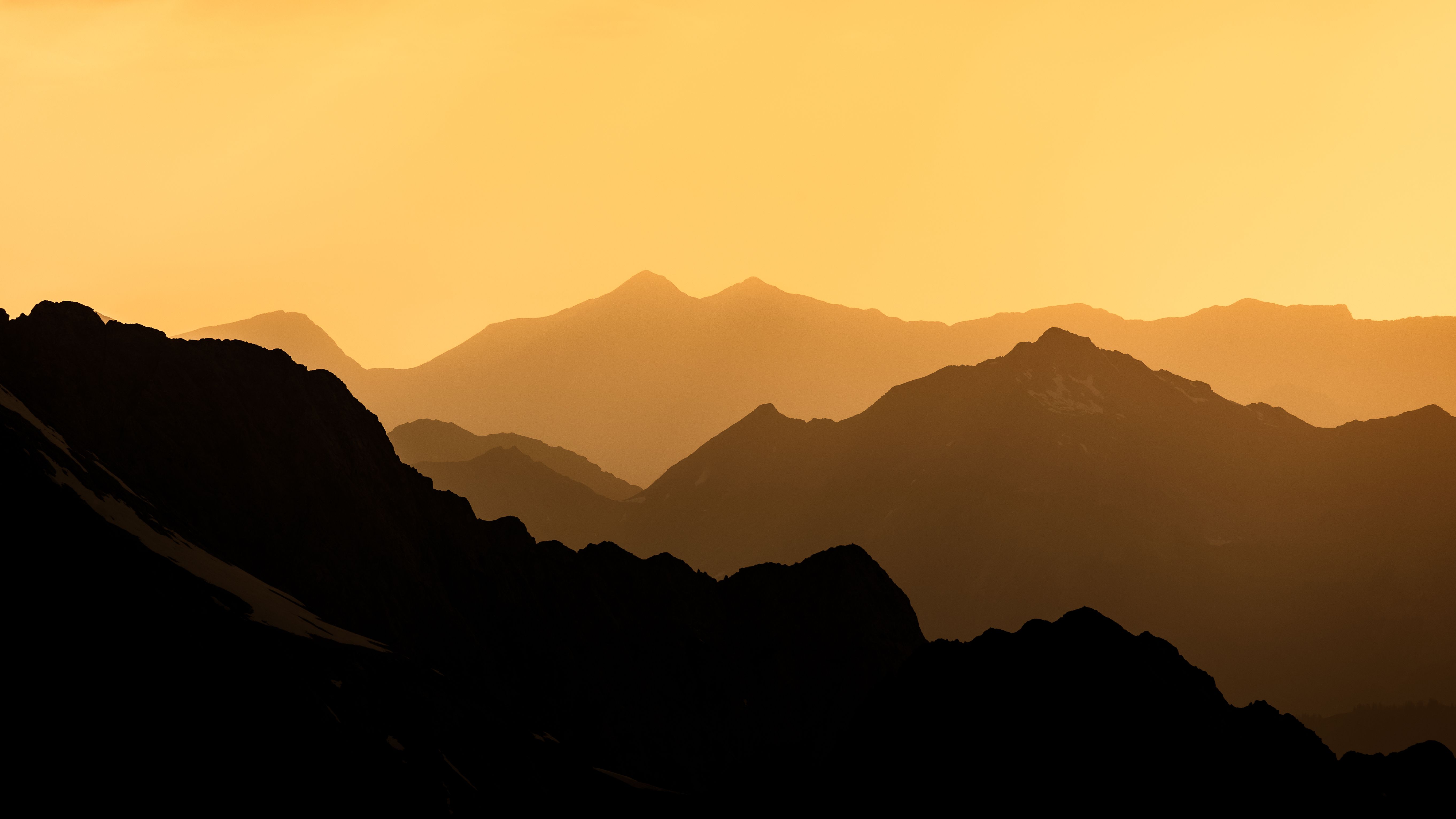 Captivating silhouette of mountains at sunset, creating a serene and magical landscape.