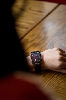 A close-up shot of a smartwatch on a wrist showing a heart rate of 104 bpm.