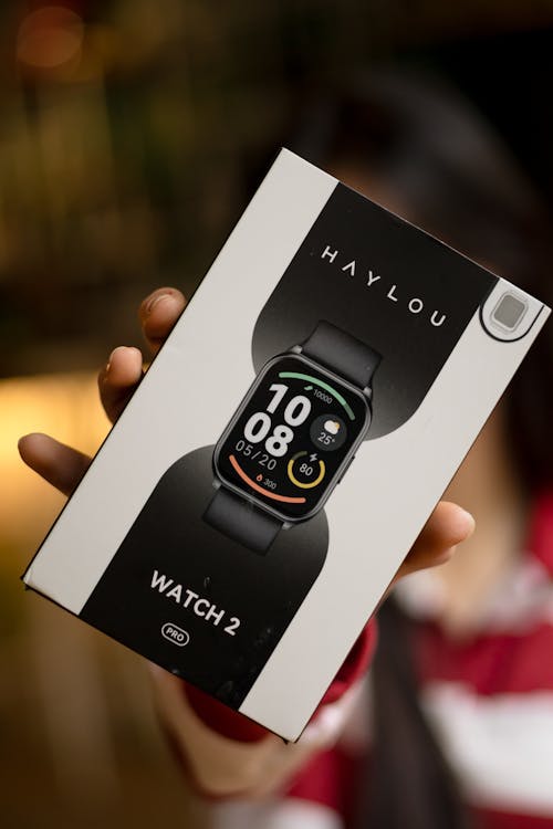 Close-up of a Person Holding a Box with a Haylou Smartwatch