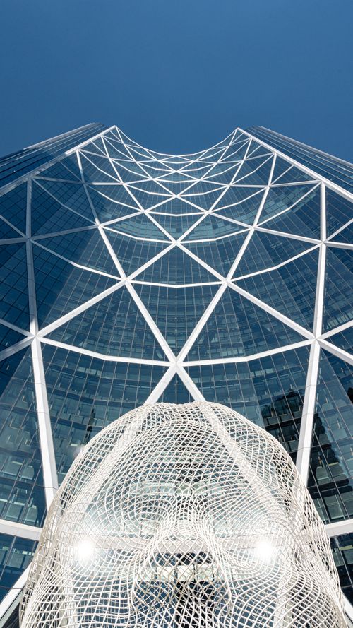 Free Low angle view of The Bow skyscraper and a public art sculpture in Calgary, Alberta. Stock Photo