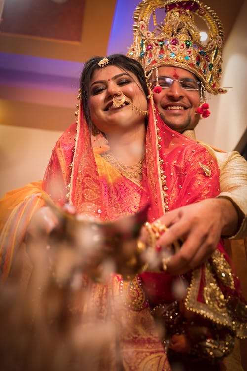 Hugging Newlyweds in Traditional Clothing