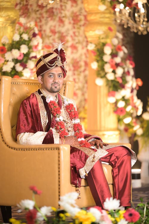 Groom Sitting in Traditional Clothing