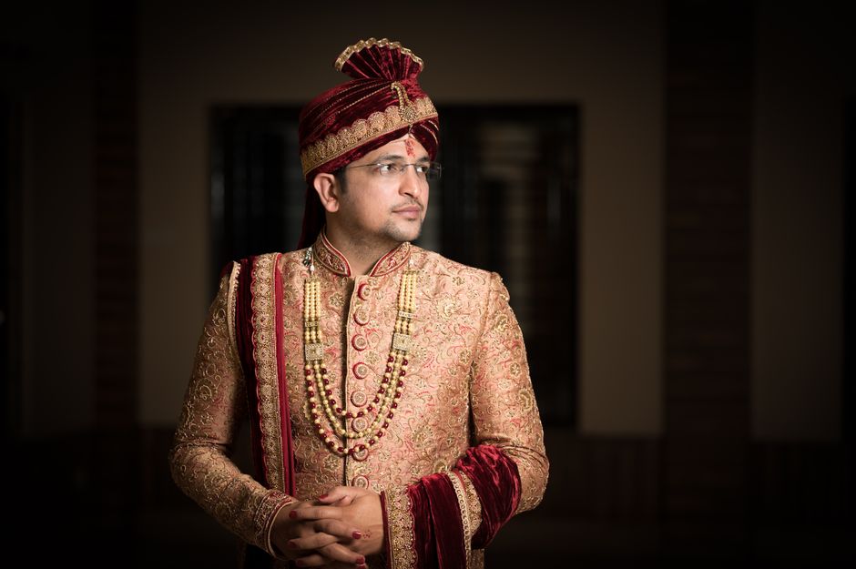 Traditional Indian groom wearing elaborate sherwani with turban and kalgi