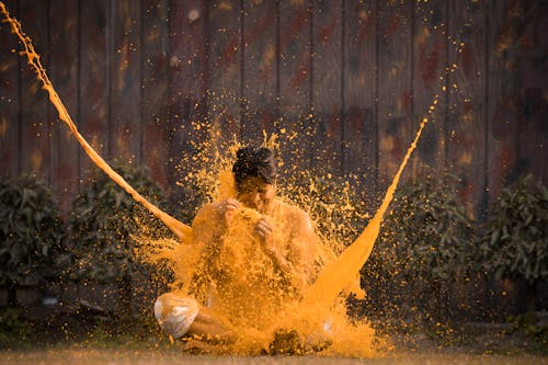 A man is covered in orange powder