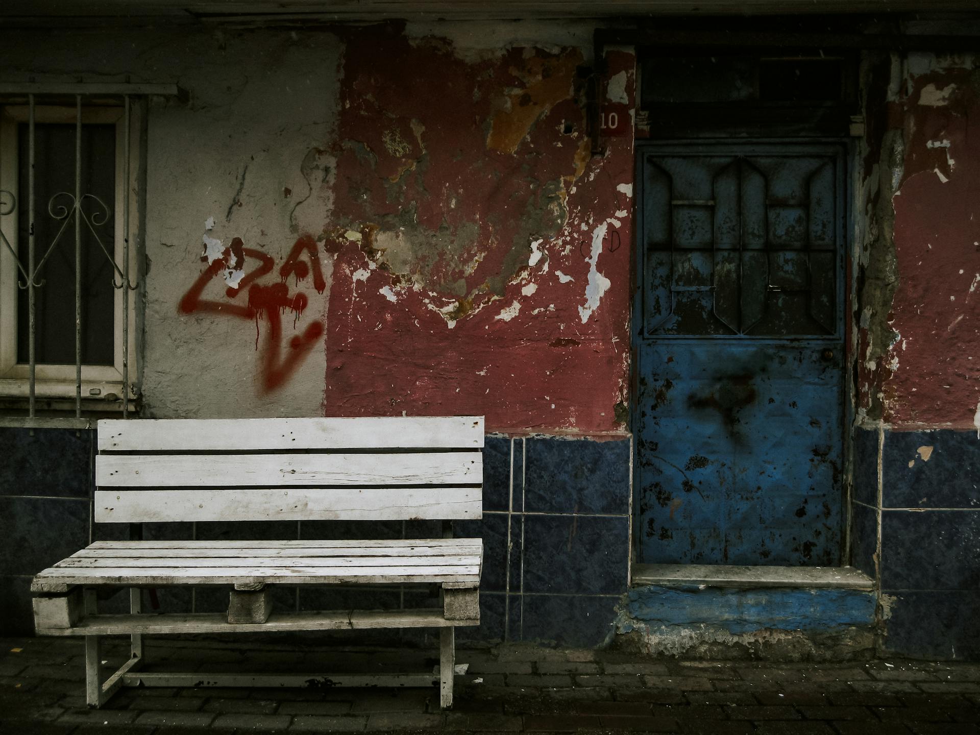 Bench by Damaged House Wall