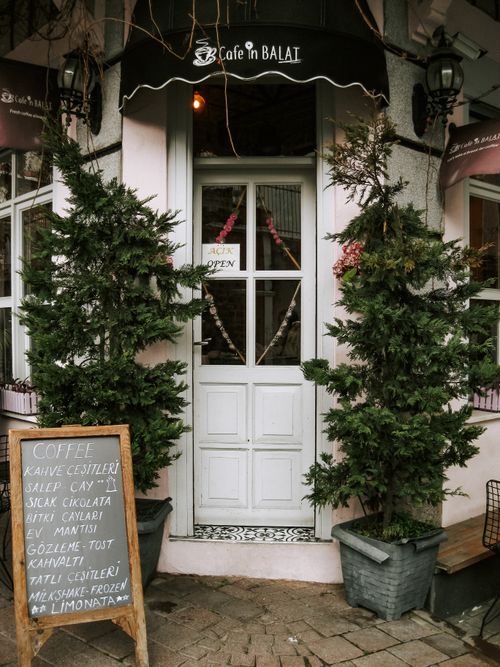 Free Cozy café entrance in Balat, Istanbul with menu board and plants. Stock Photo