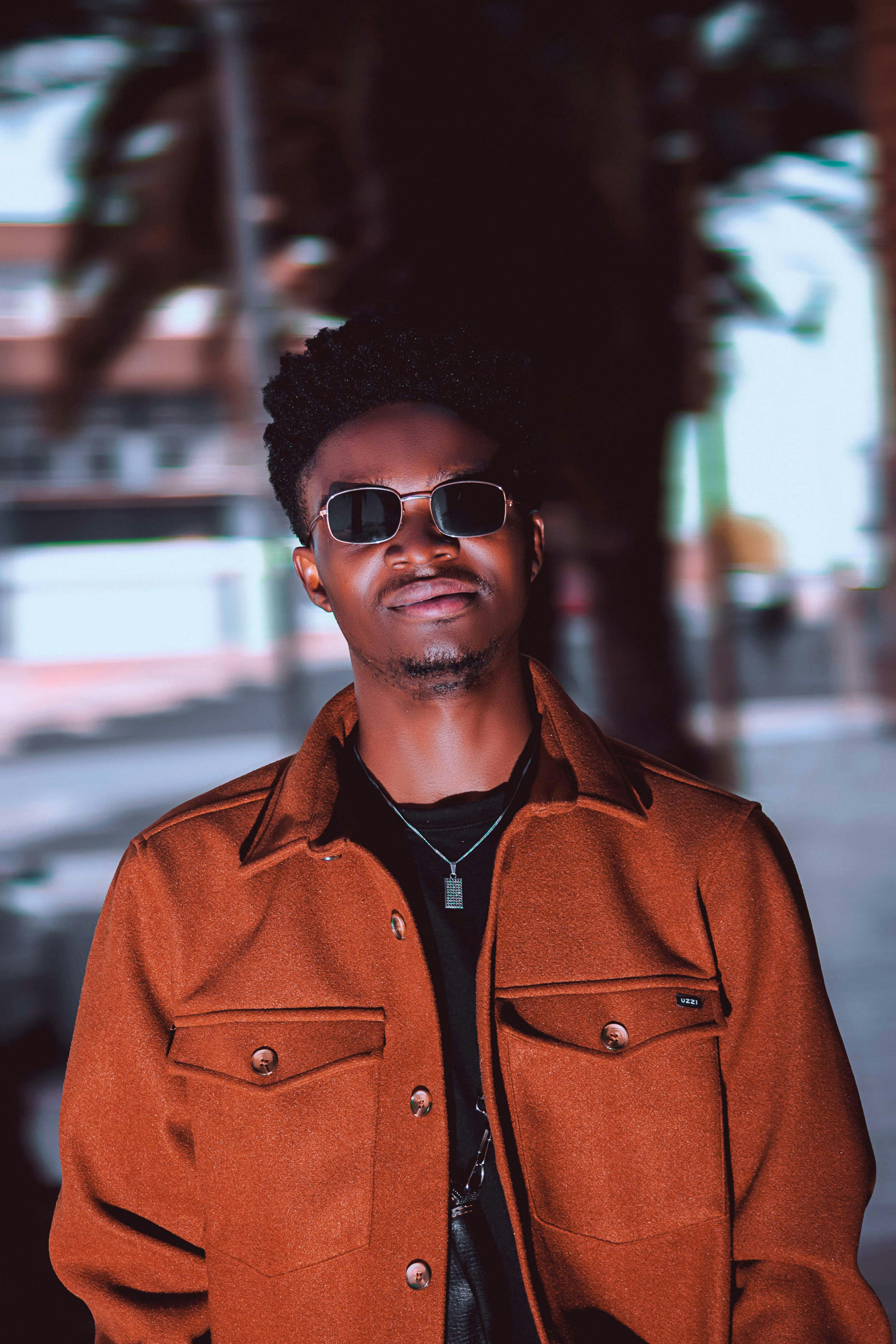 Fashionable man wearing a coat and sunglasses in Johannesburg, South Africa.