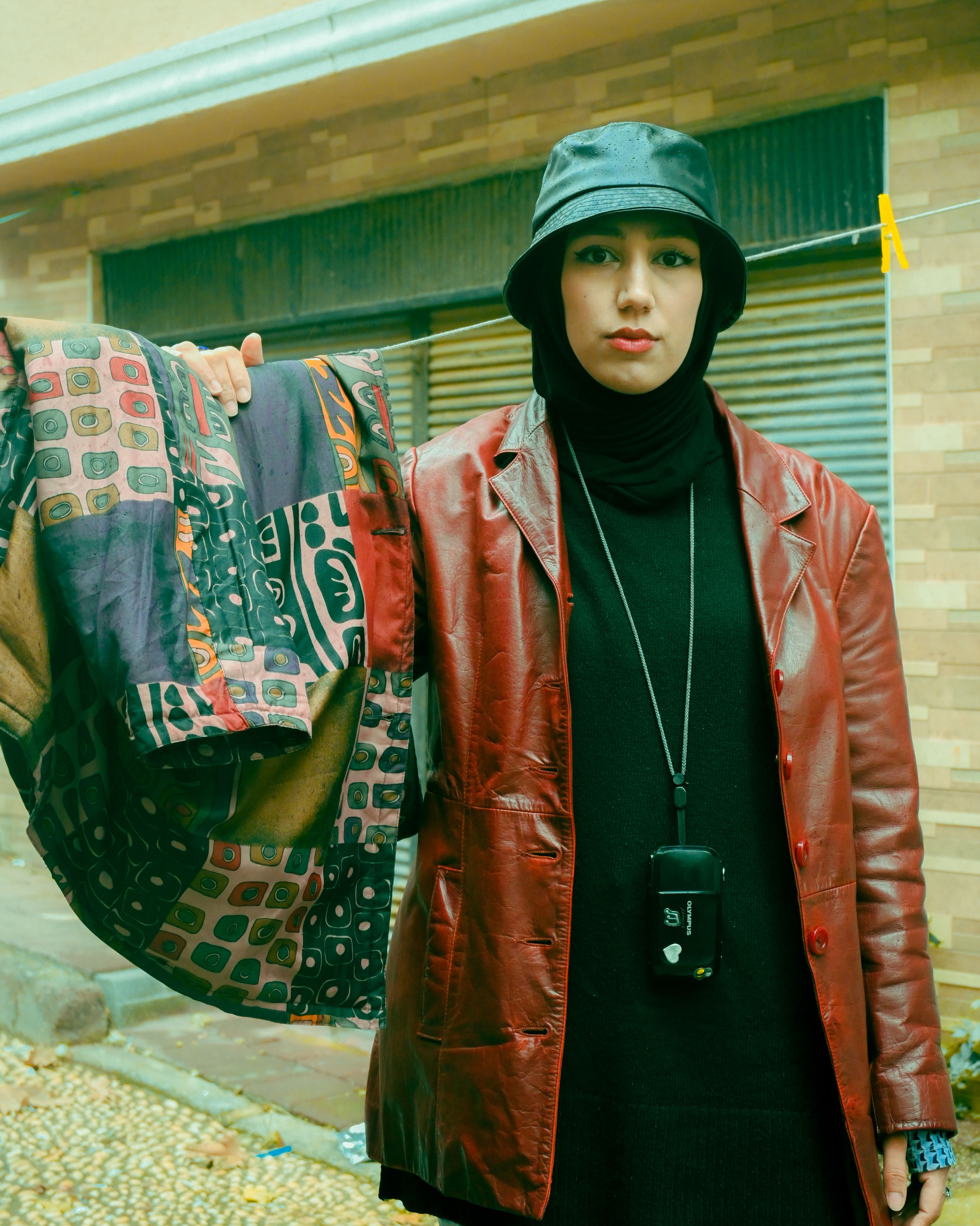 Stylish woman in a red jacket with a patterned scarf in İstanbul street.