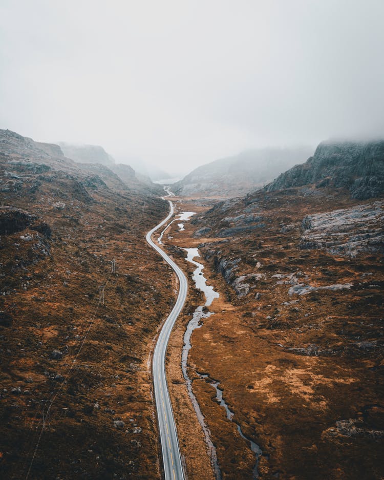 Road Between Hills On Foggy Day In Norway