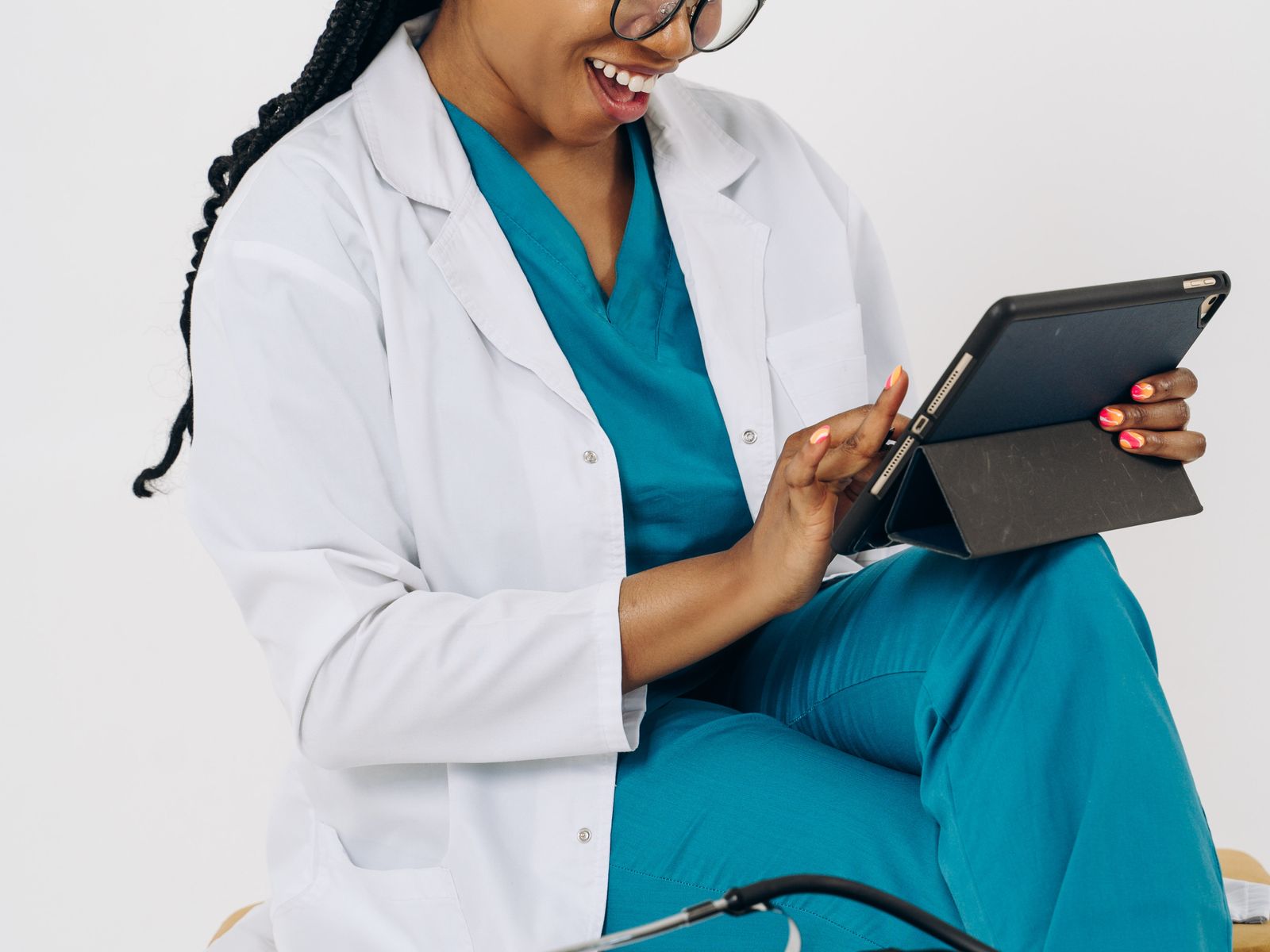 Healthcare professional using a laptop or tablet in a modern practice office