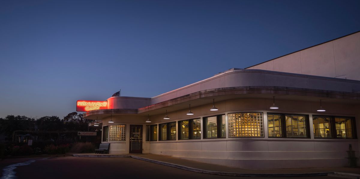 Historic corner cafe building aglow during evening twilight