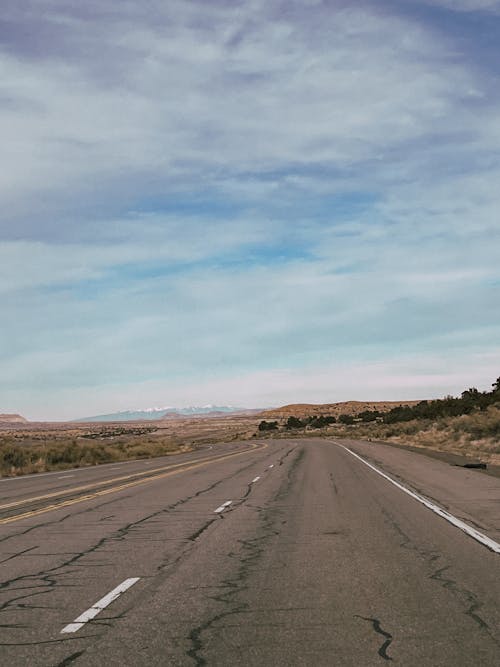 Cracked Asphalt Road Through the Desert