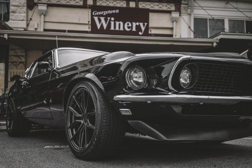 Free A vintage black Mustang parked outside Georgetown Winery, showcasing urban style and muscle car appeal. Stock Photo