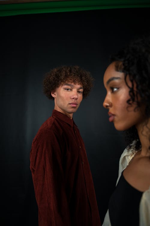 Young Man in Brown Shirt and Woman Posing in Studio