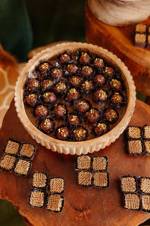 Free Top view of chocolate truffles with nuts on a wooden table, ready to serve. Stock Photo