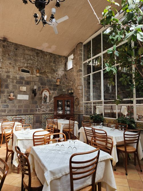 Free Charming dining area in Sorrento, Italy, with rustic decor and natural light. Stock Photo
