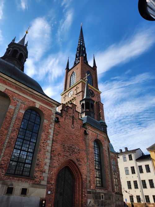 Free Riddarholmen Church with its distinctive spire towering under a clear blue sky in Stockholm, Sweden. Stock Photo