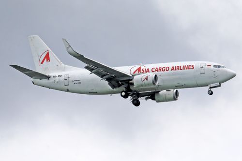 Free Boeing 737 from Asia Cargo Airlines flying against a cloudy sky. Stock Photo