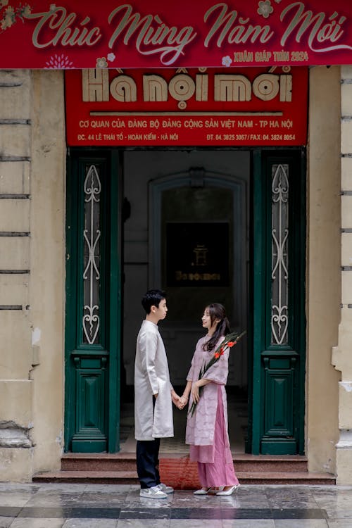 A couple standing in front of a building