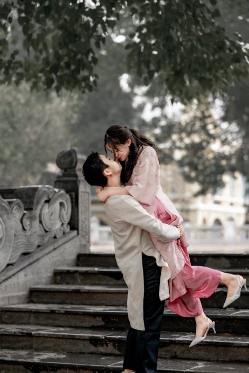 Man Lifting and Hugging Woman at Park