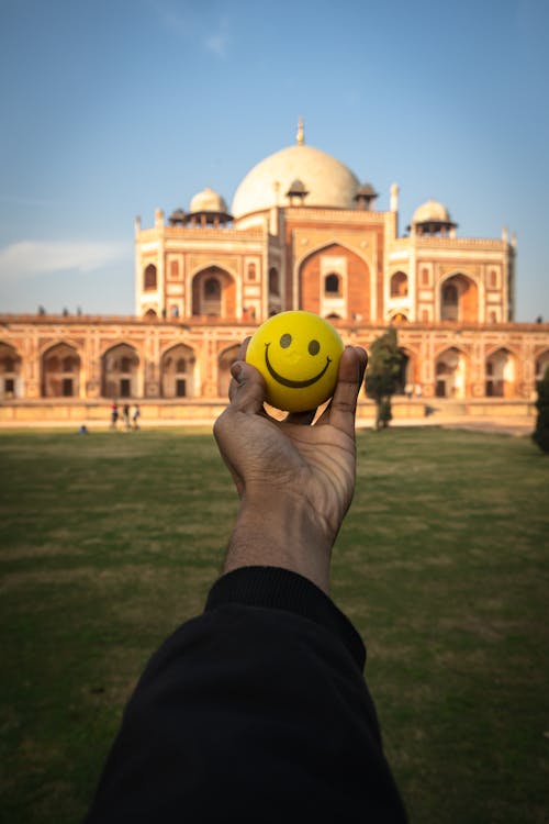 Ball in a Hand, and the Humayuns Tomb in Background