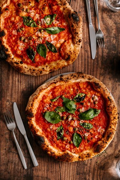 Wood-fired margherita pizzas on a table — Rene Strgar on Pexels