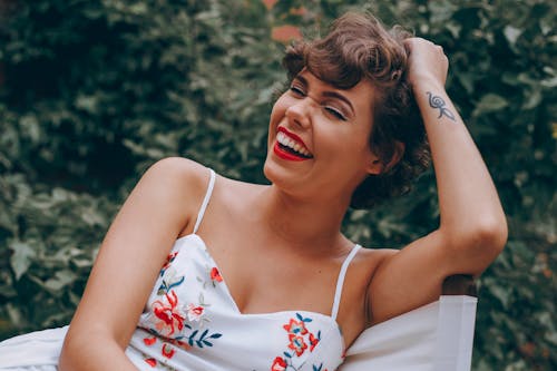 Free Sitting and Laughing Woman Stock Photo