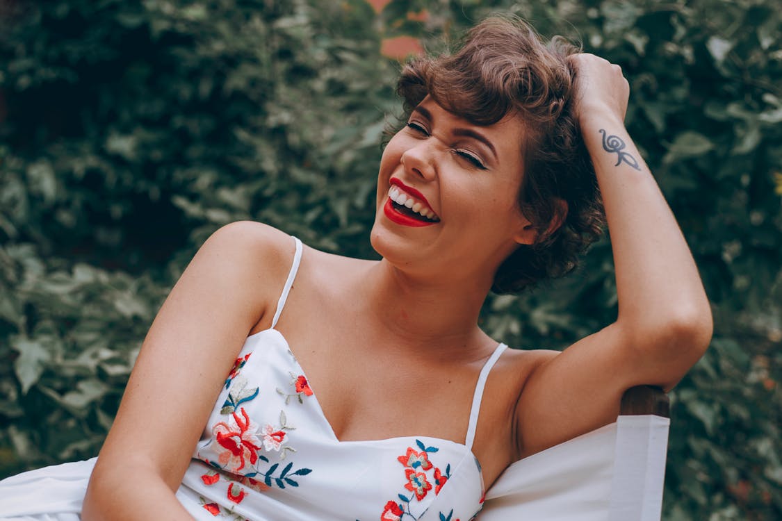 Free Sitting and Laughing Woman Stock Photo