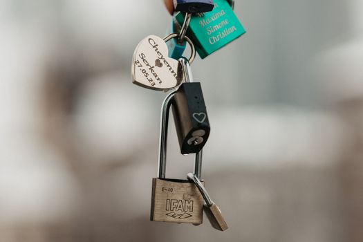 Close-up image of various personalized love padlocks symbolizing commitment and affection.