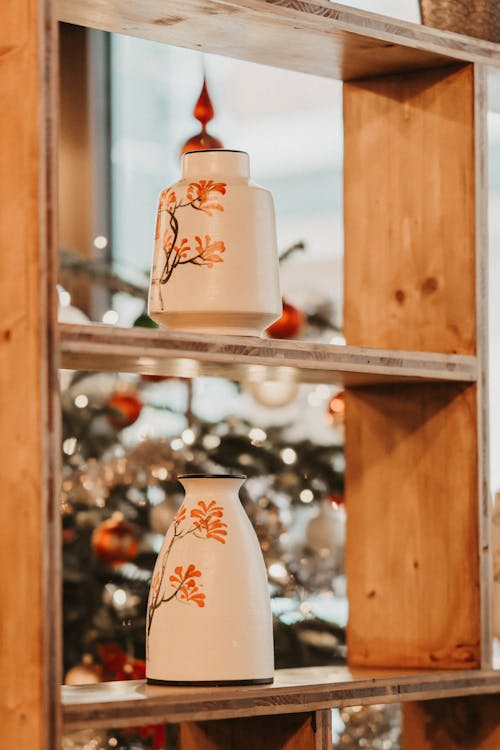 Ornate Ceramic Vessels on Shelves 