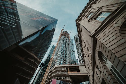 A view of tall buildings with a crane in the background