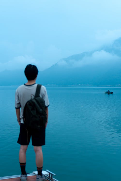Man with Backpack Looking at Lake
