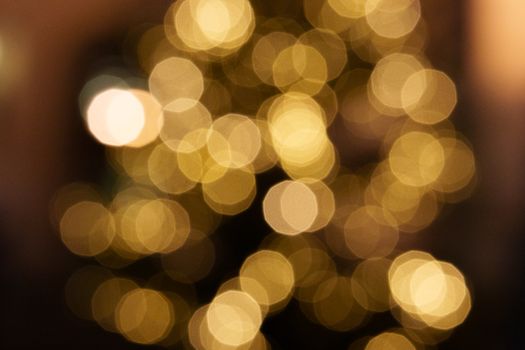 Warm and festive bokeh effect with golden circular lights, perfect for holiday and celebration themes.
