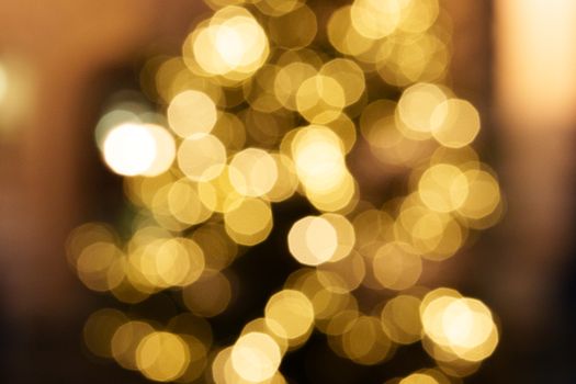Warm, defocused golden bokeh lights evoke a festive and cozy atmosphere, perfect for holiday themes.