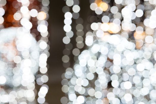 A blurred abstract bokeh image showcasing festive holiday lights in a defocused style.