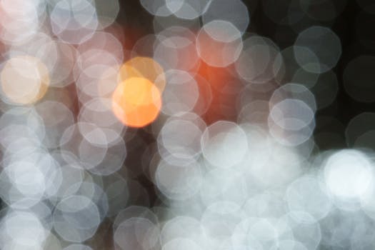 A vibrant bokeh effect with defocused lights creating an abstract pattern in soft colors.