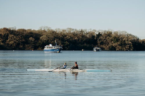 People Rowing on Lake