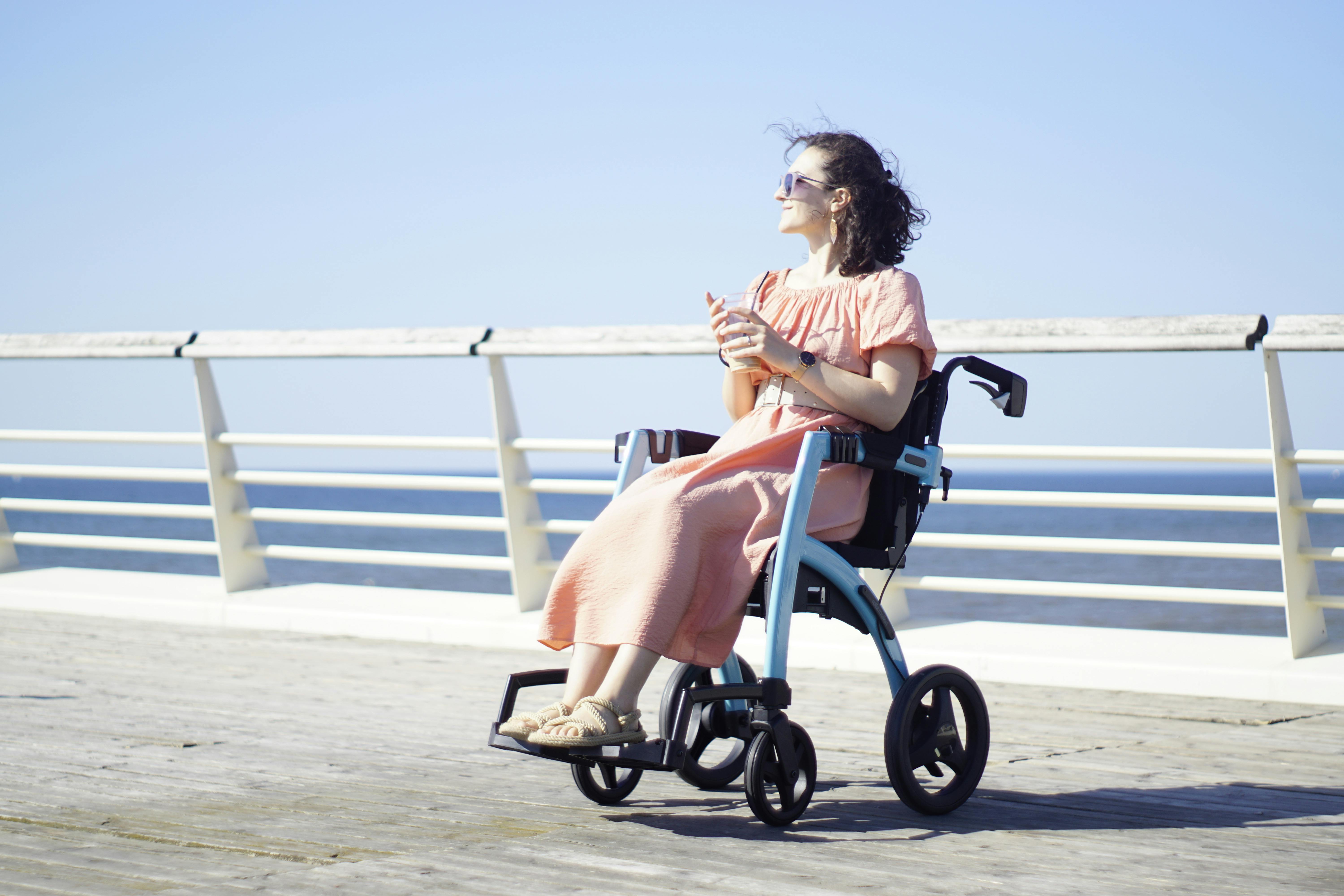 Free Woman Sits on Transit Chair at Pier Stock Photo