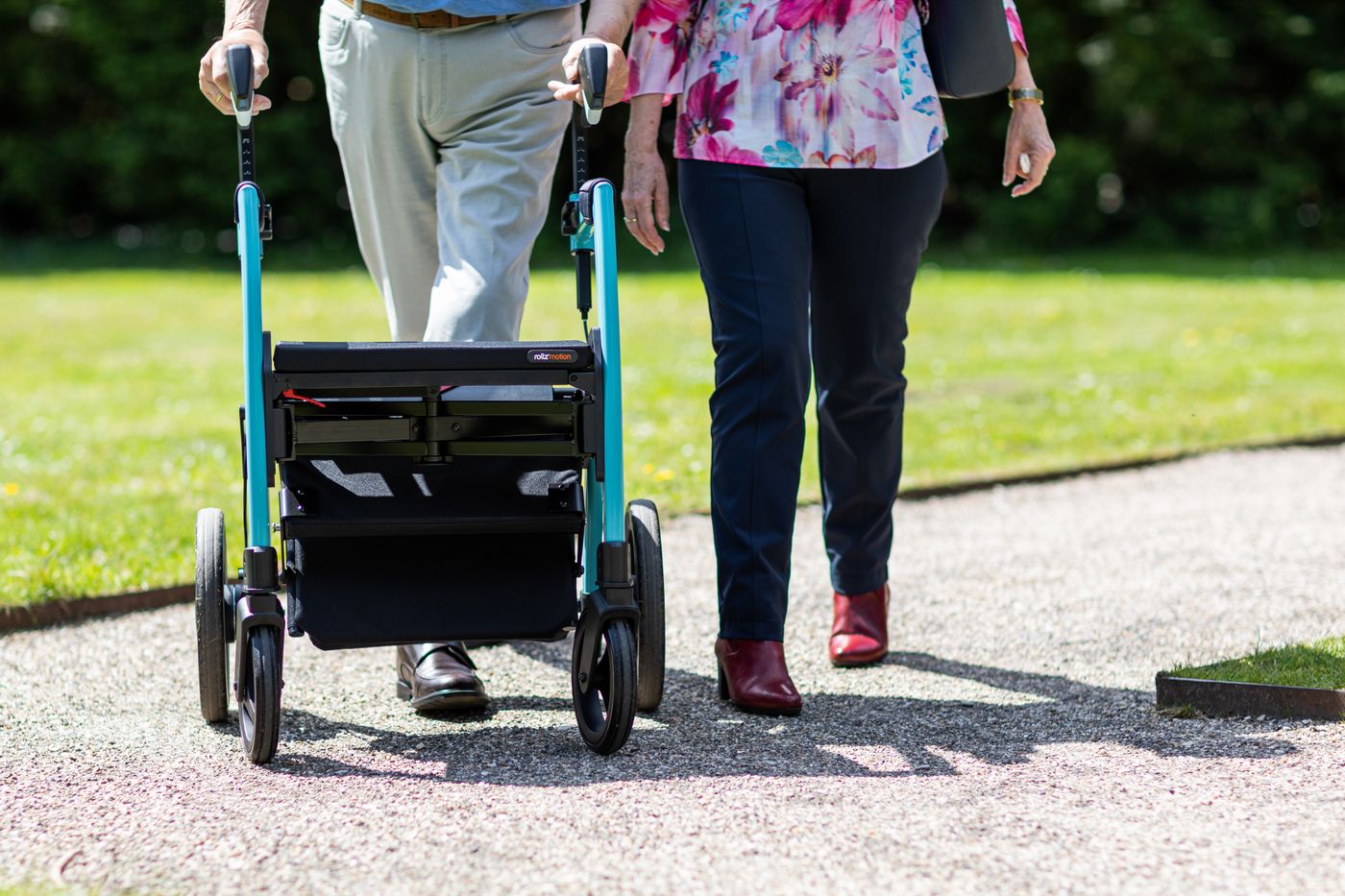 Two people walking outdoors on a sunny day