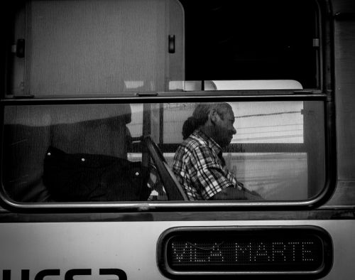Free A man reflects while sitting on a train, captured in black and white. Stock Photo