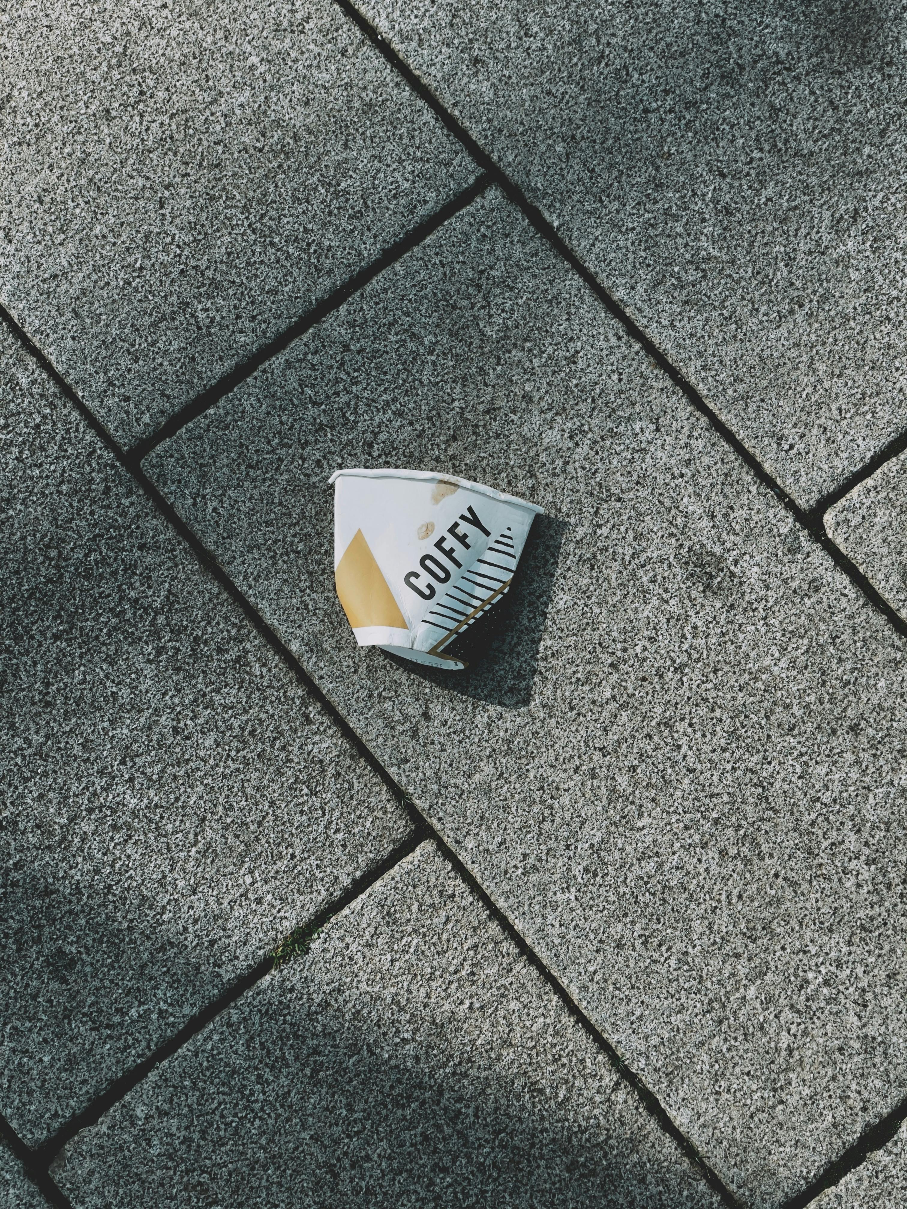 Paper Cup on Pavement · Free Stock Photo