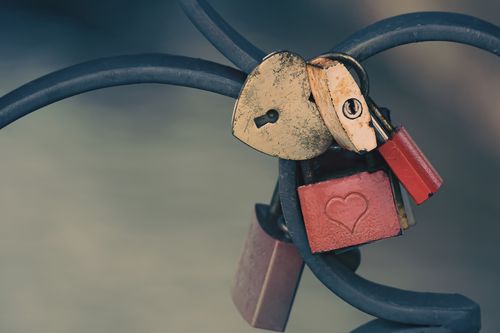 Free A collection of heart-shaped padlocks on a fence, symbolizing promises of love and commitment. Stock Photo