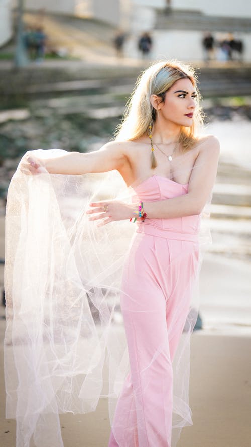Blonde Woman in Pink Clothes and Holding Veil
