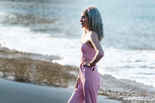 Blonde Woman in Pink Clothes on Sea Shore
