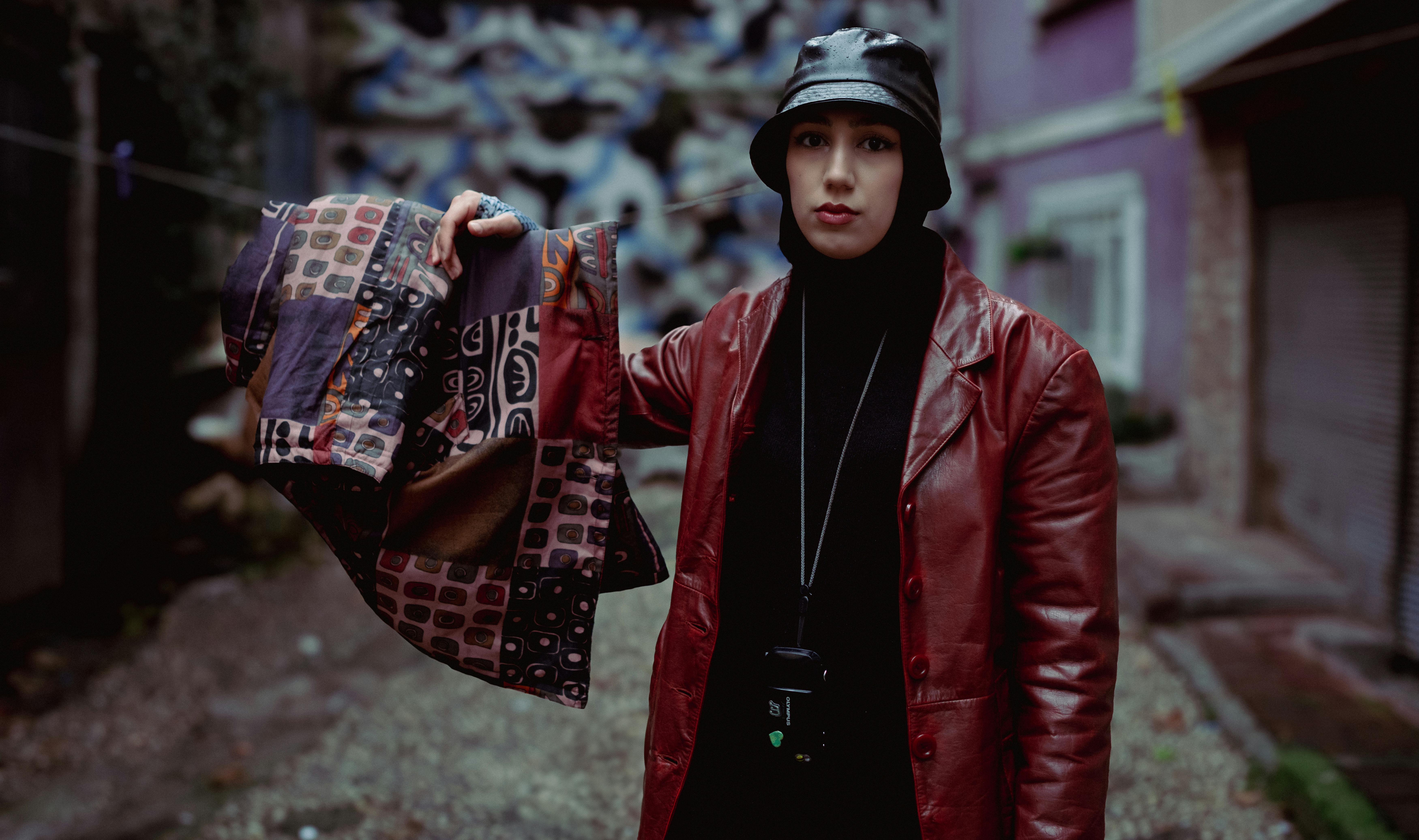 a man in a red jacket holding a bag