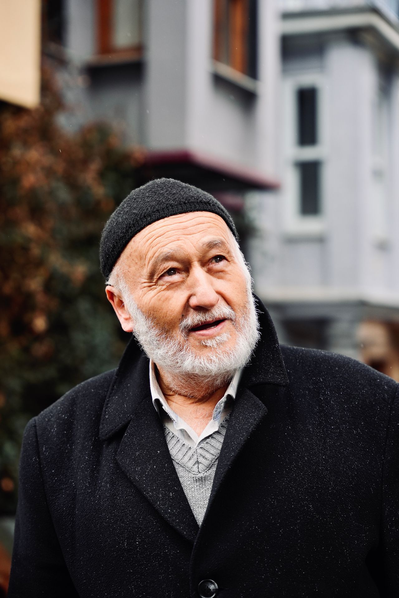 Elderly man in a warm wool winter coat and knit cap