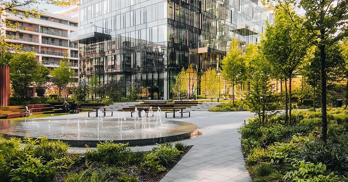 Illustrative stock photo of landscaped grounds beside a modern office building